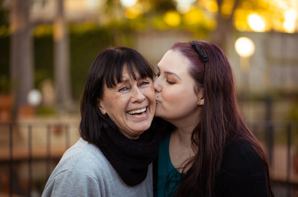 Daughter gives her mum a kiss.
